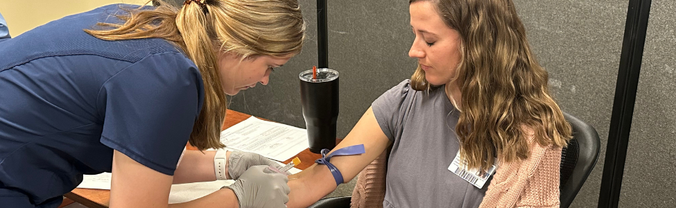 Nurse drawing woman's blood