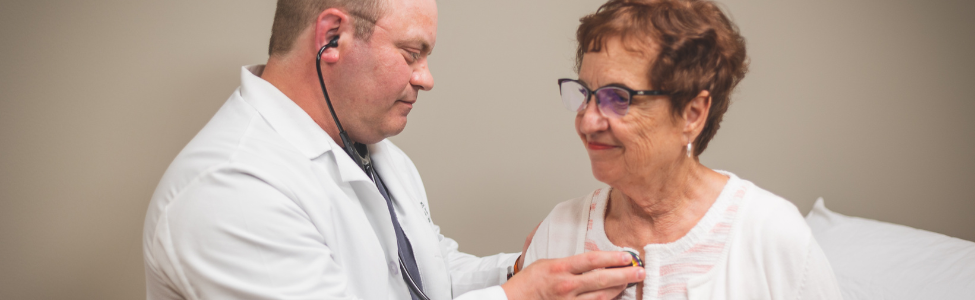 Dr. Eric Rome listening to a patient's heart.