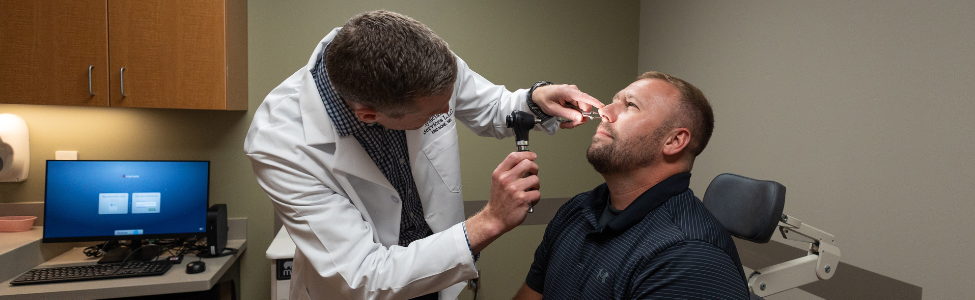 ENT provider examining a patient's nostrils.