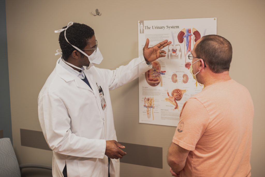 Dr. Yemi consults with a patient at Faith Regional Physician Services Urology in Norfolk.