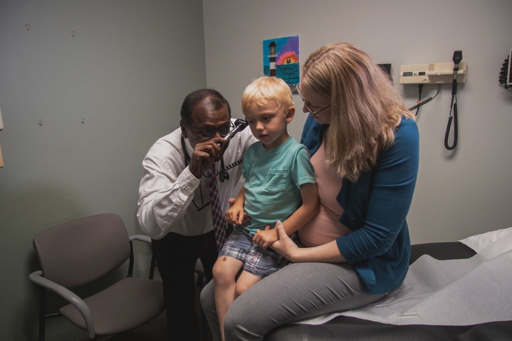 Dr. Chandra Ponniah examines a pediatric patient at Faith Regional Physician Services Norfolk Family Medicine.