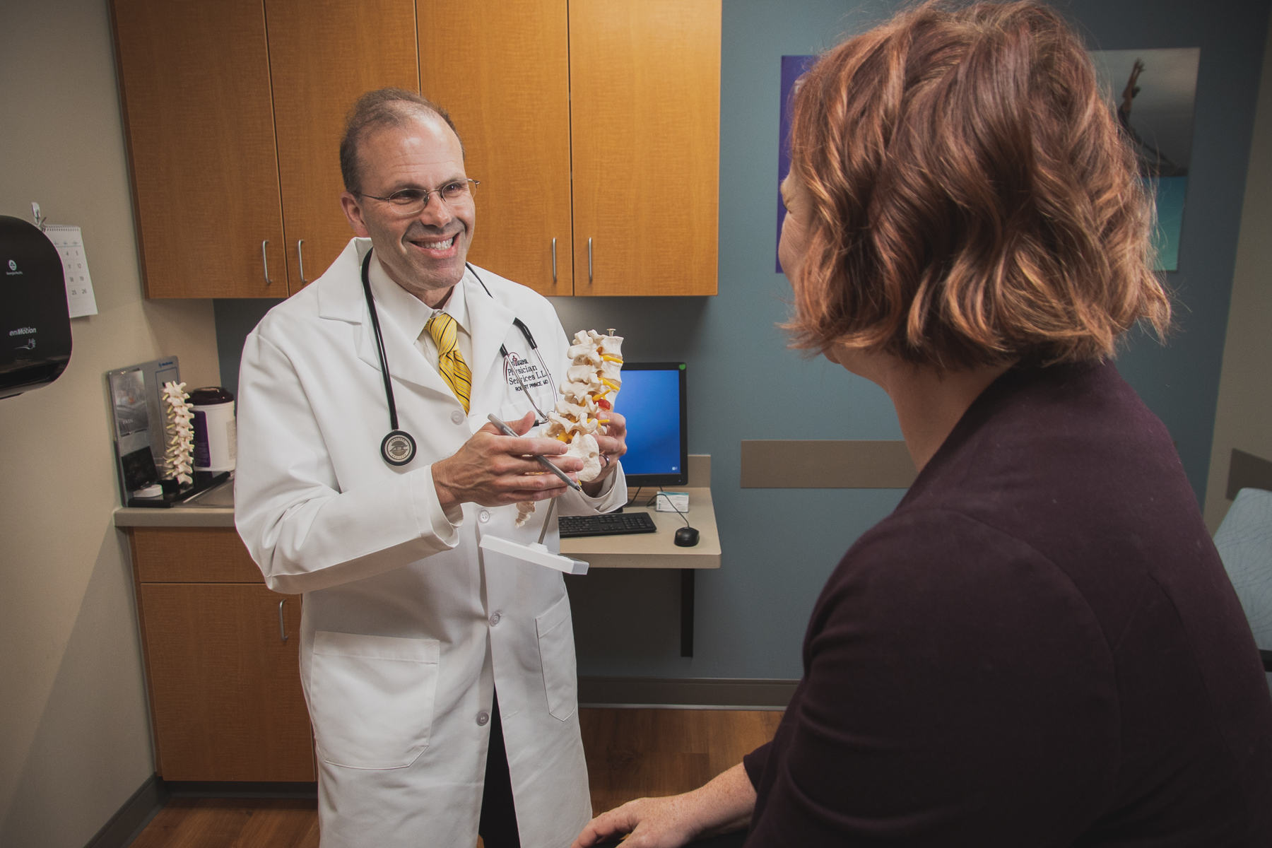 Dr. Robert Prince discussing back pain with a patient. 