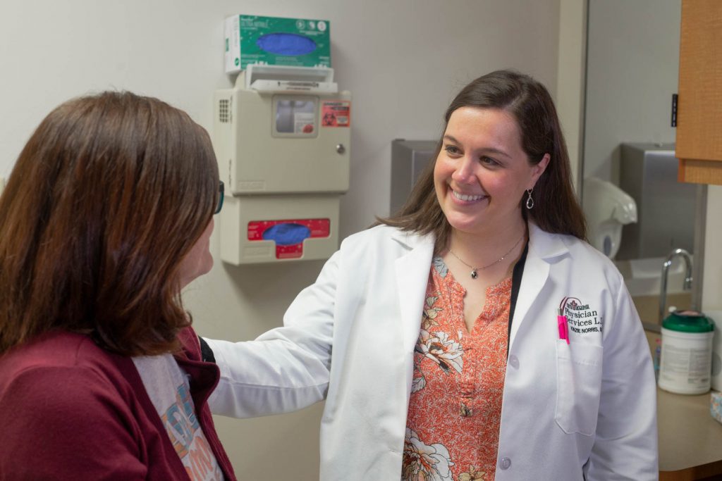 Dr. Kenzie Norris talks with a patient at Faith Regional Physician Services Breast Care in Norfolk.