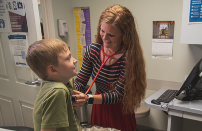 Family medicine provider, Angie Smutny, APRN, caring for a patient.