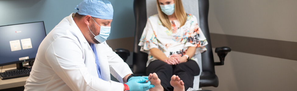 Dr. Zackary Gangwer examining a patients foot.
