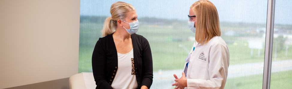 Brooke Cemper, APRN, speaking with a patient.