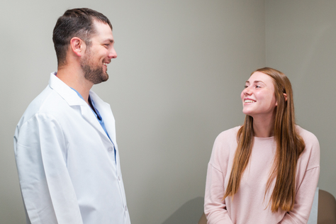 Dr. Alex Laudenklos, OB/GYN, caring for a patient.