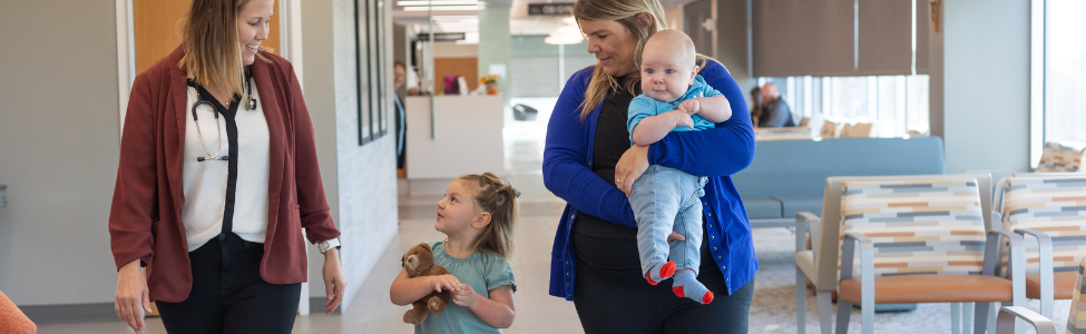 Dr. Samantha Rohe with pediatric patients and mother.