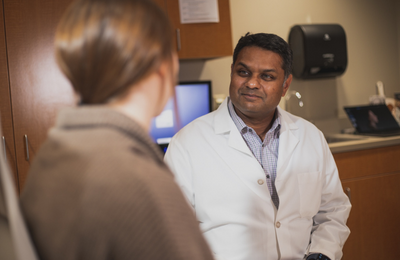 Dr. Mark Shashikant, plastic and reconstructive surgeon, caring for a patient.