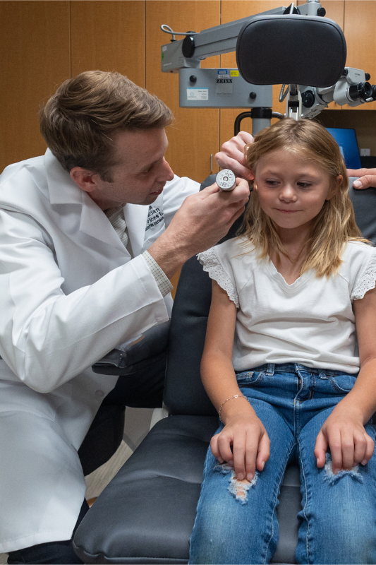 Dr. Oltman examining young girls ear