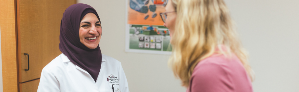 Dr. Enas Al Zaghal meeting with a patient.